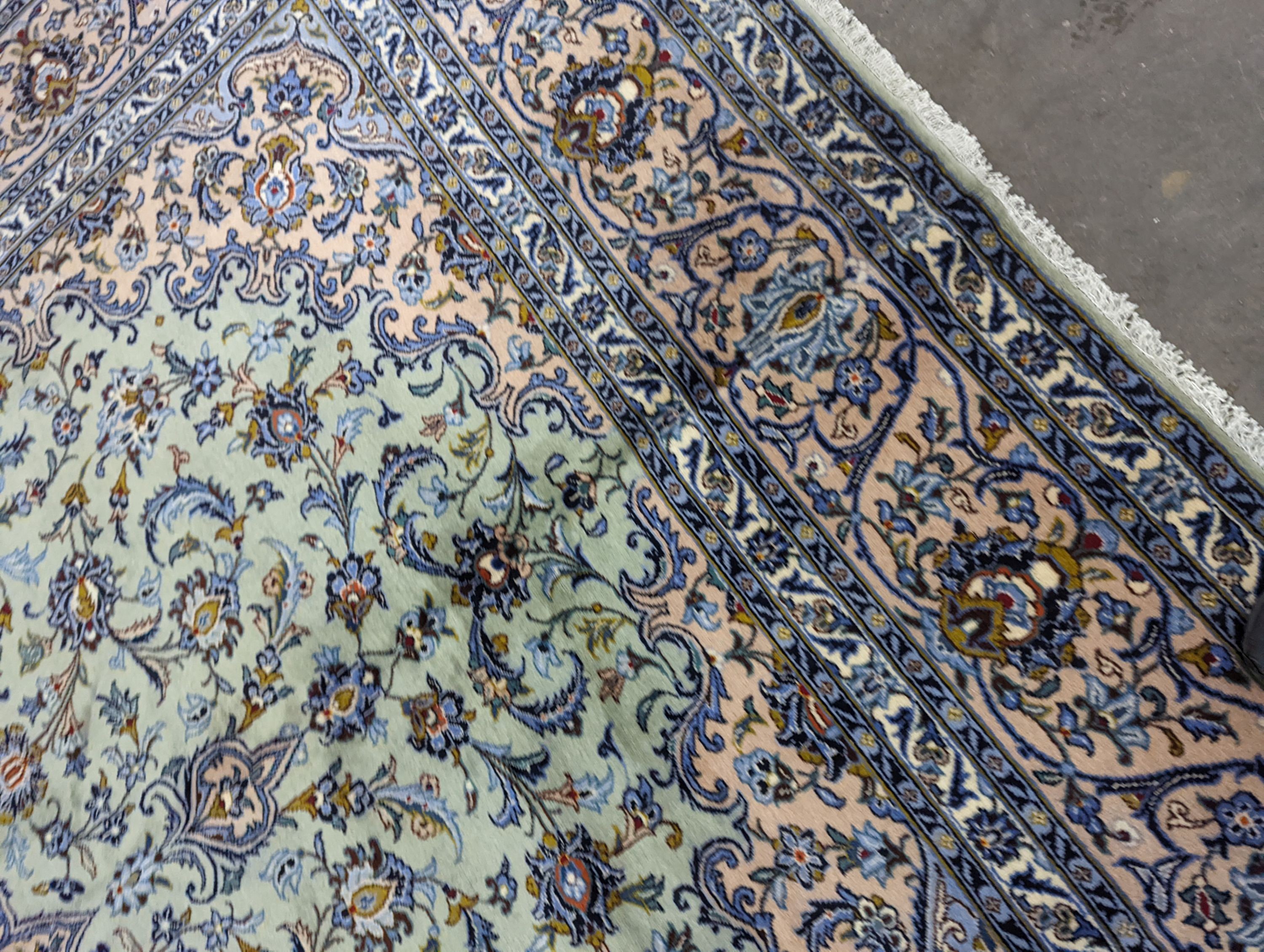 A Kashan pale green ground carpet, 410 x 296cm